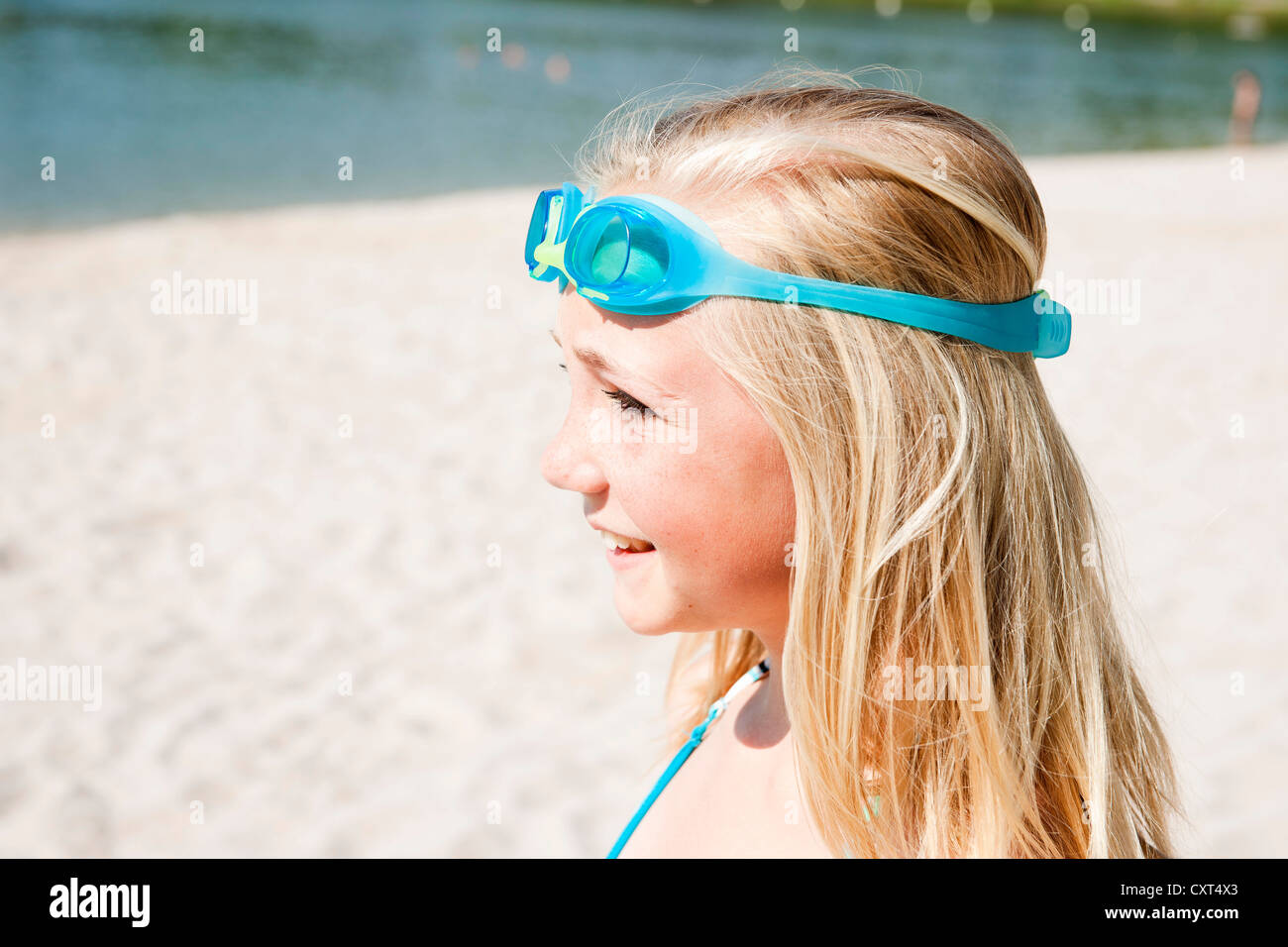 Girl wearing swim goggles on a beach, portrait Stock Photo Alamy