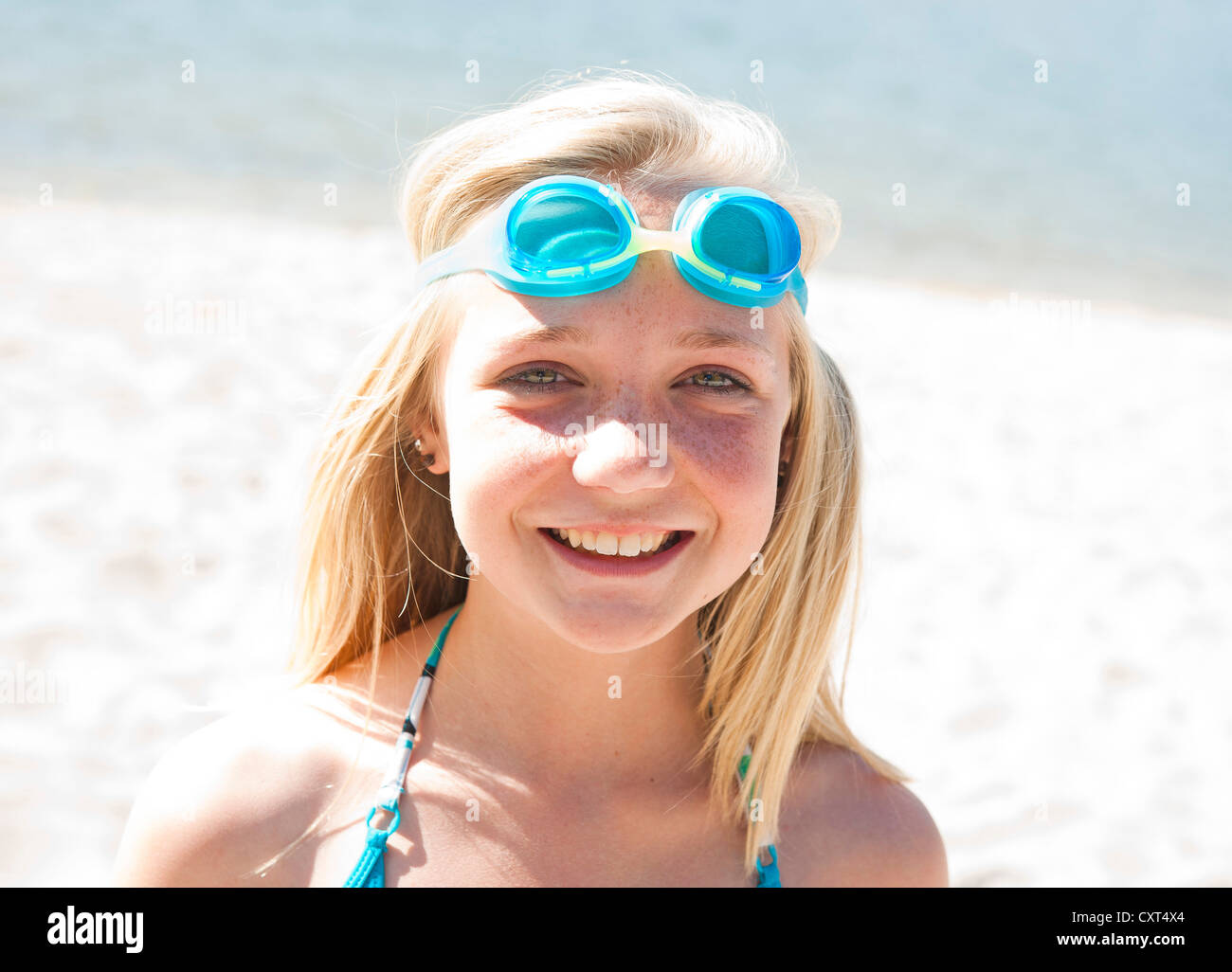 Girl wearing swim goggles on a beach, portrait Stock Photo Alamy