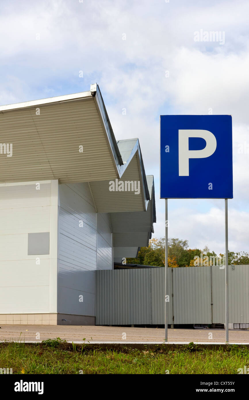 car parking near a standard warehouse. Mass production metal buildings