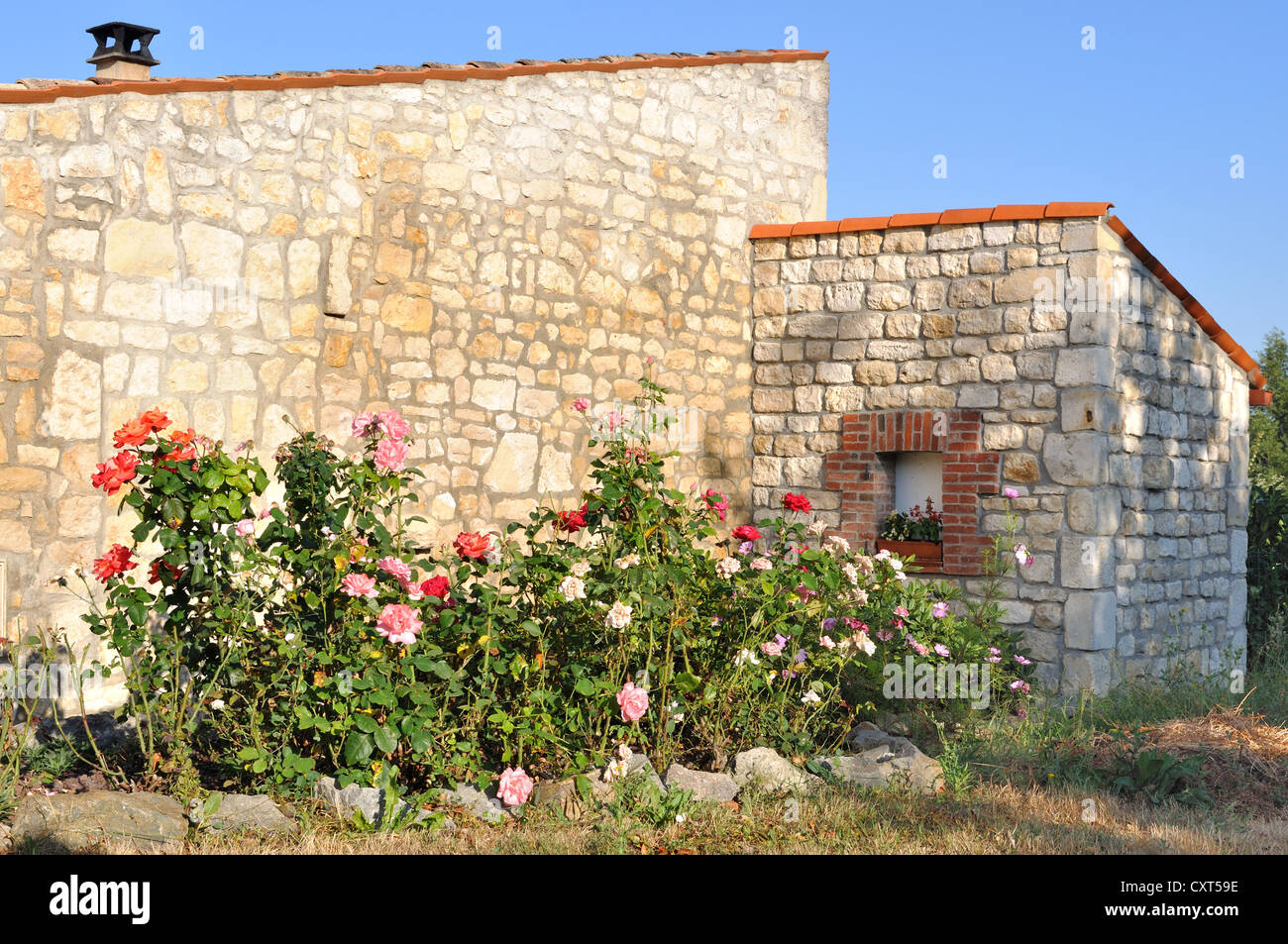 flower border in front of a renovated old stone house Stock Photo Alamy