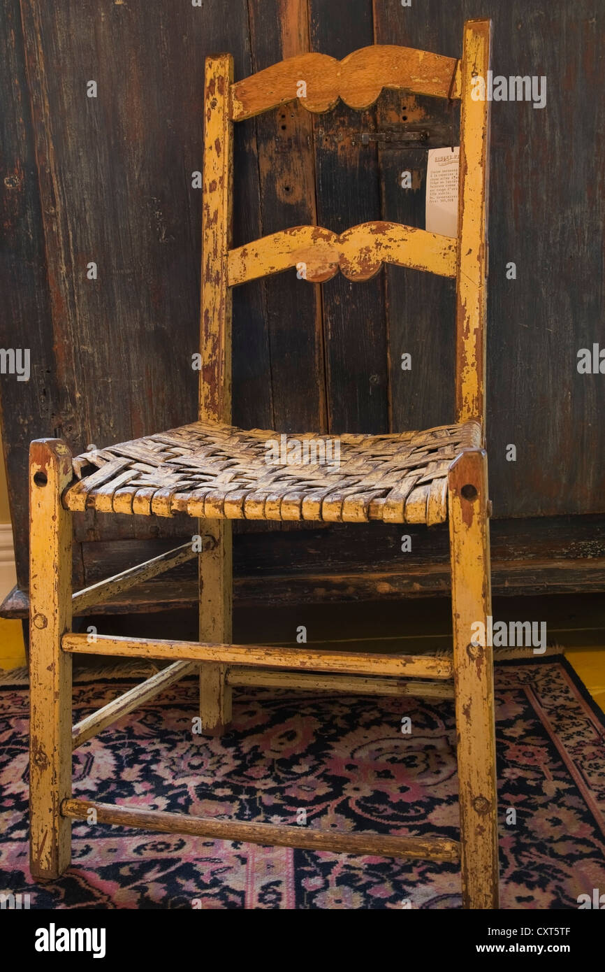Antique wooden chair and armoire inside an old residential home and antique store, Lanaudiere, Quebec, Canada. This image is Stock Photo