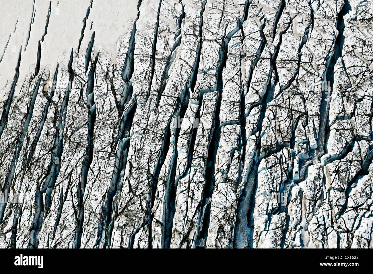 Aerial view, ice crevices and structures of volcanic ash and black lava in the ice and snow of the Vatnajoekull glacier, Iceland Stock Photo