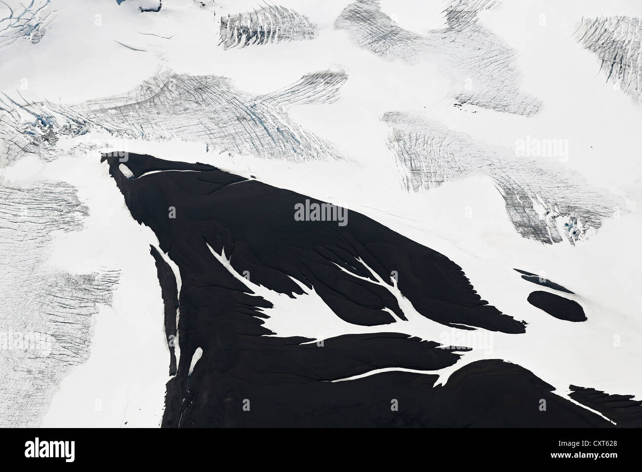 Aerial view, ice crevices and structures of volcanic ash and black lava in the ice and snow of the Vatnajoekull glacier, Iceland Stock Photo