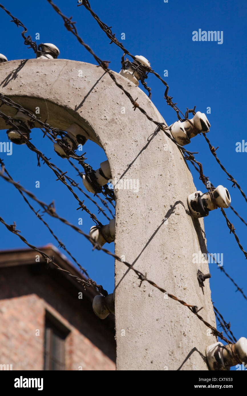 Barb wire electric fence and building inside the Auschwitz I former Nazi Concentration Camp, Auschwitz, Poland, Europe Stock Photo