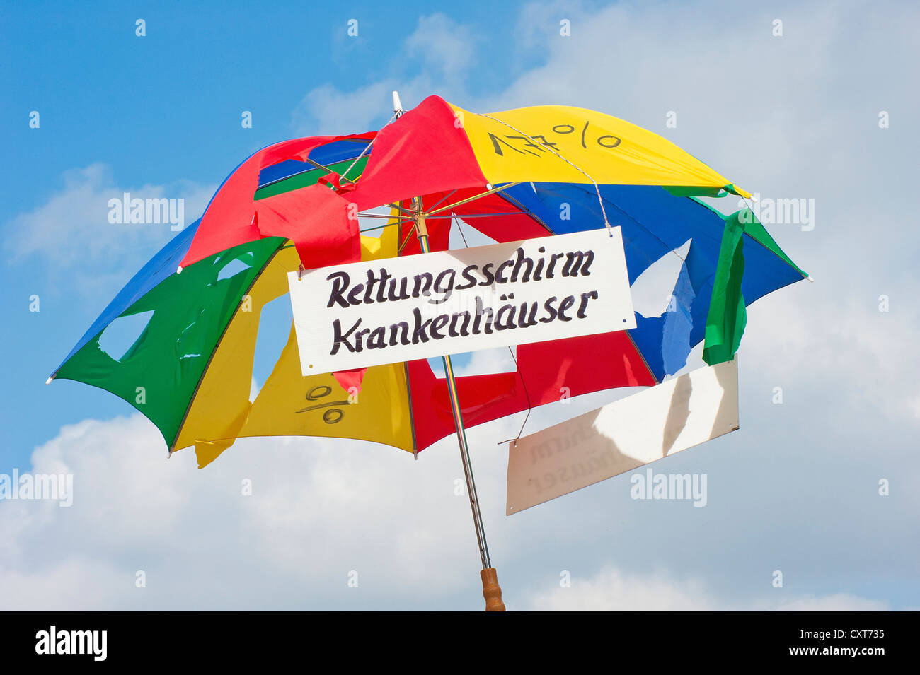 Broken umbrella with sign 'Rettungsschirm Krankenhaeuser', German for 'rescue umbrella for hospitals', 10, 000 workers from Stock Photo