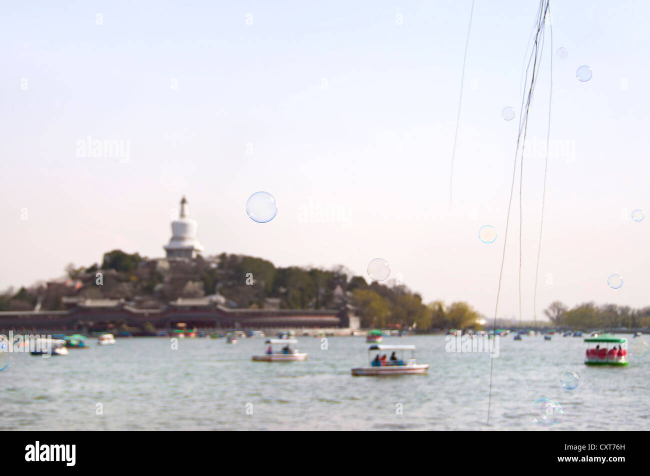 Boats on the lake around Jade Island, Beihai Park, Beijing Stock Photo