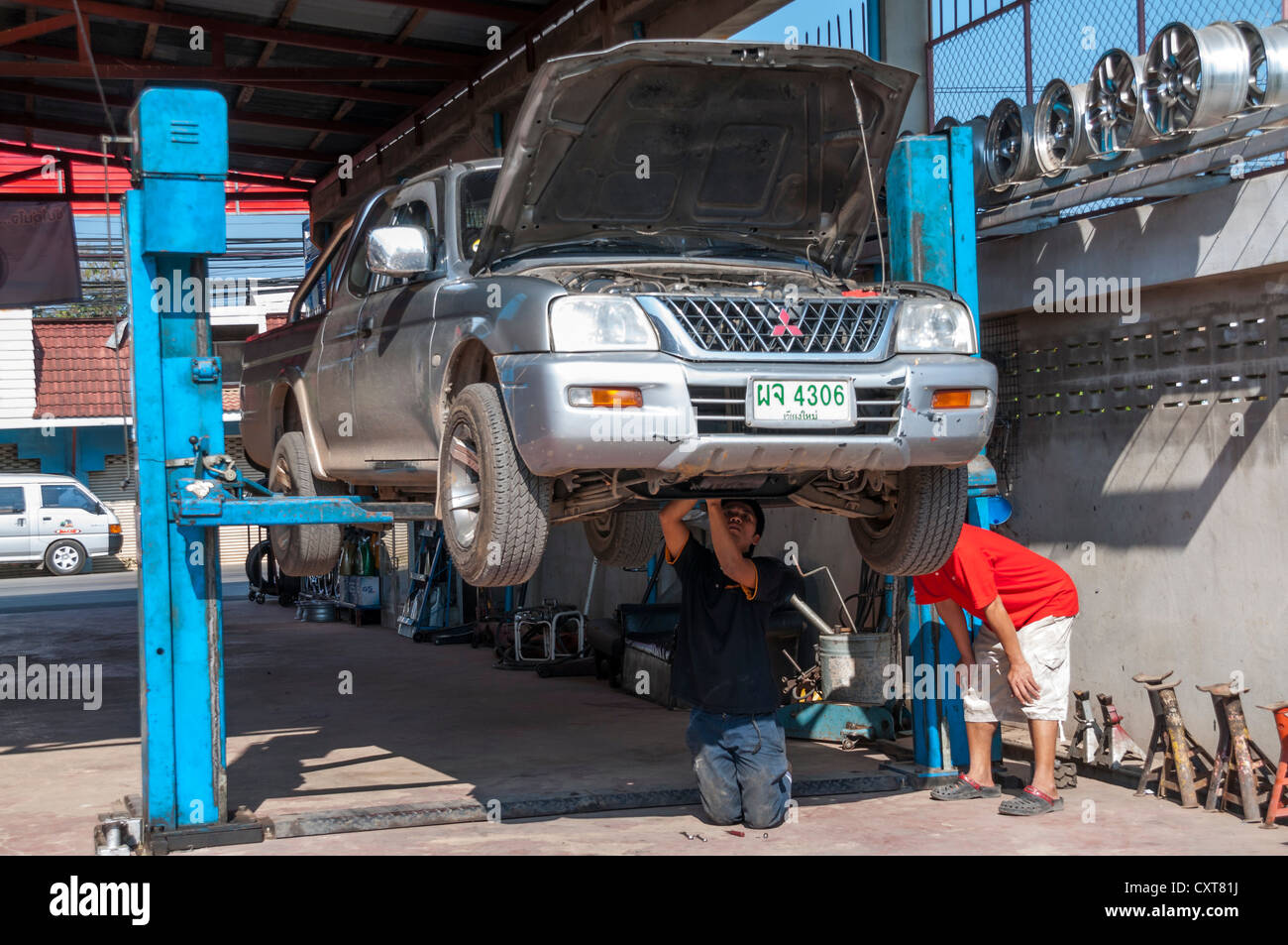 SUV or pickup on a lift or a hoist in a garage, car repair, Nan