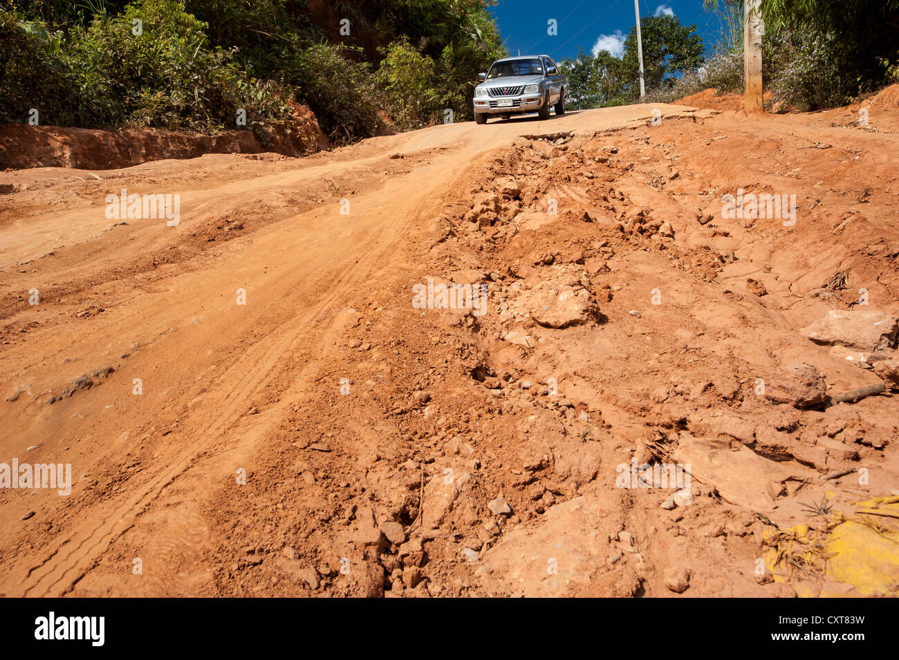 SUV or off-road vehicle at the end of a paved road, dirt road, Northern Thailand, Thailand, Asia Stock Photo