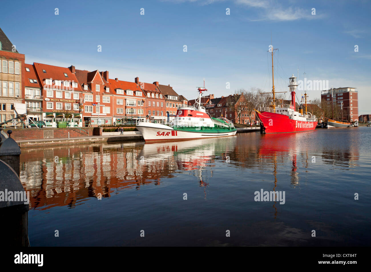 Museum ships are reflected in the water of the Ratsdelft in the harbour of Emden, East Frisia, Lower Saxony, Germany Stock Photo