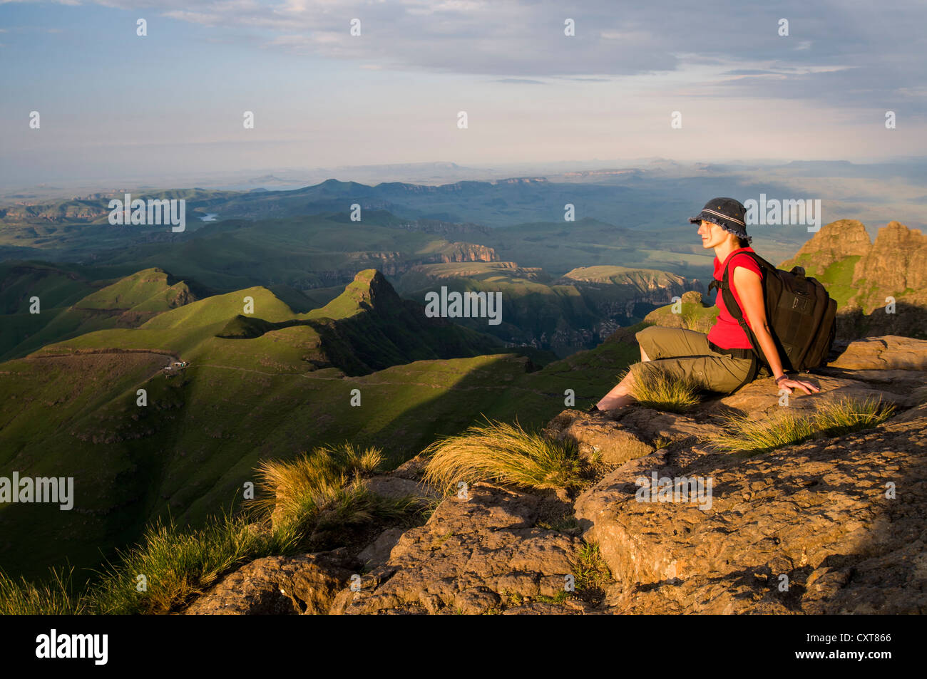 Seated woman admiring the landscape, Sentinel Hiking Trail, Drakensberg Mountains, KwaZulu-Natal, South Africa, Africa Stock Photo