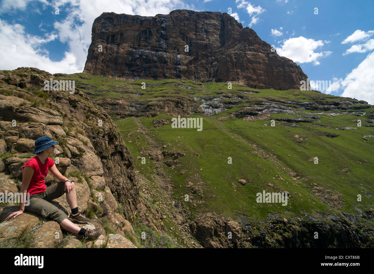 Woman taking a break on the hiking trail, Sentinel Hiking Trail, Drakensberg Mountains, KwaZulu-Natal, South Africa, Africa Stock Photo
