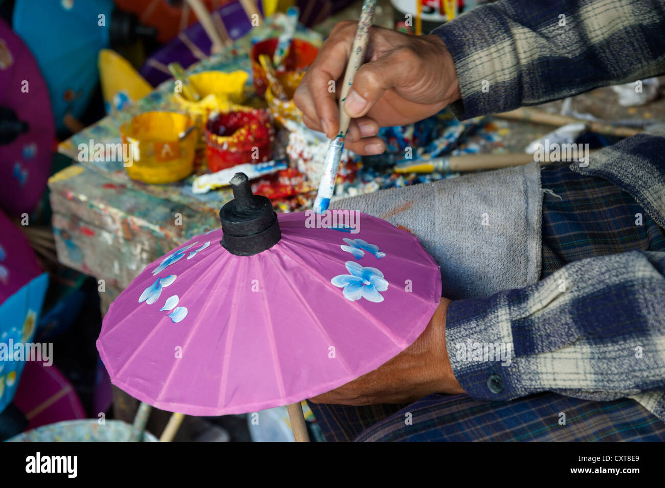 Craftsman producing a colourful paper umbrella, Bo Sang, Chiang Mai, Northern Thailand, Thailand, Asia Stock Photo