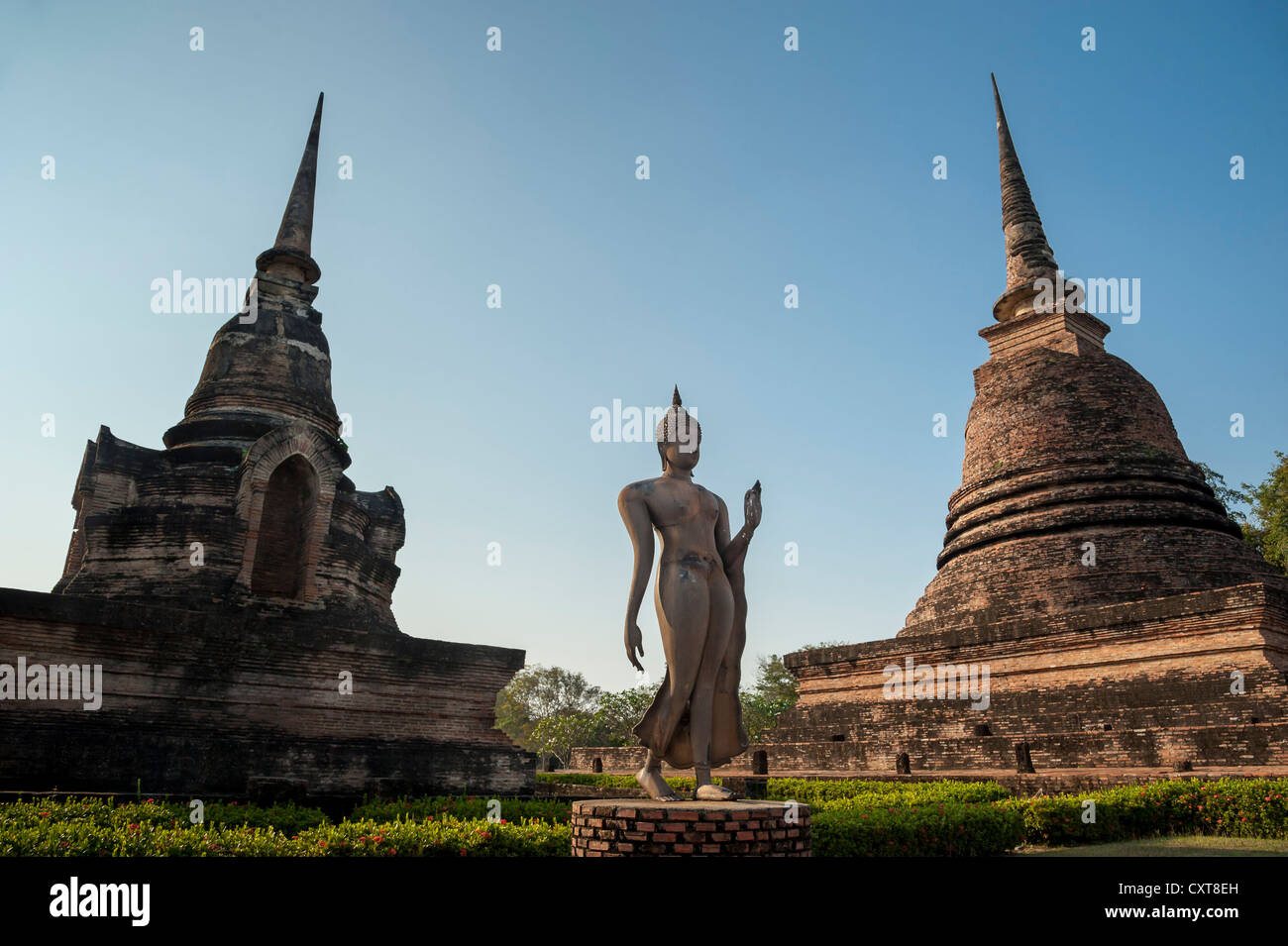 Walking Buddha statue in Wat Sa Si or Sra Sri temple, Sukhothai Historical Park, UNESCO World Heritage Site, Northern Thailand Stock Photo