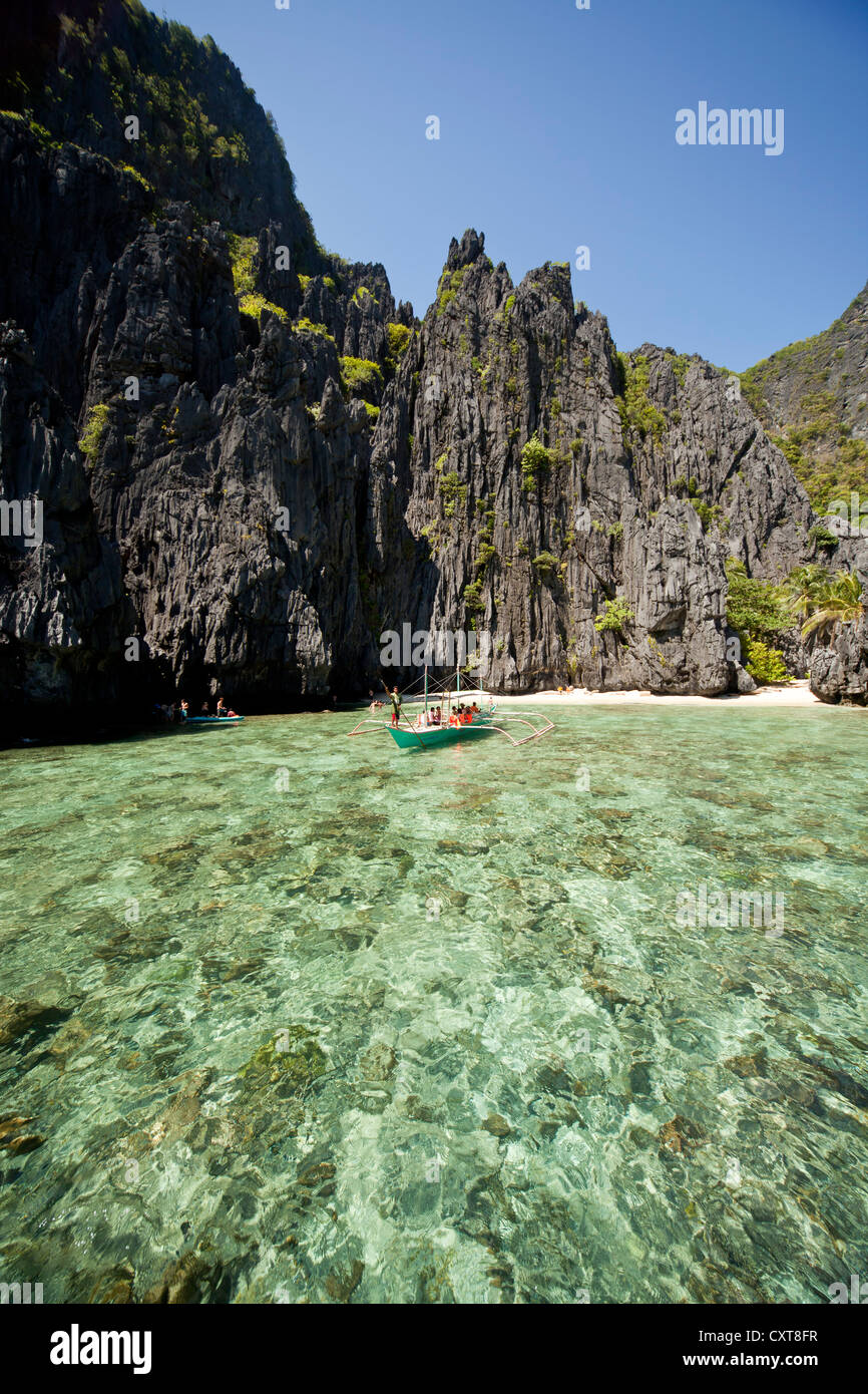 Boat off the cliff coast of Miniloc Island, El Nido, Palawan, Philippines, Asia Stock Photo