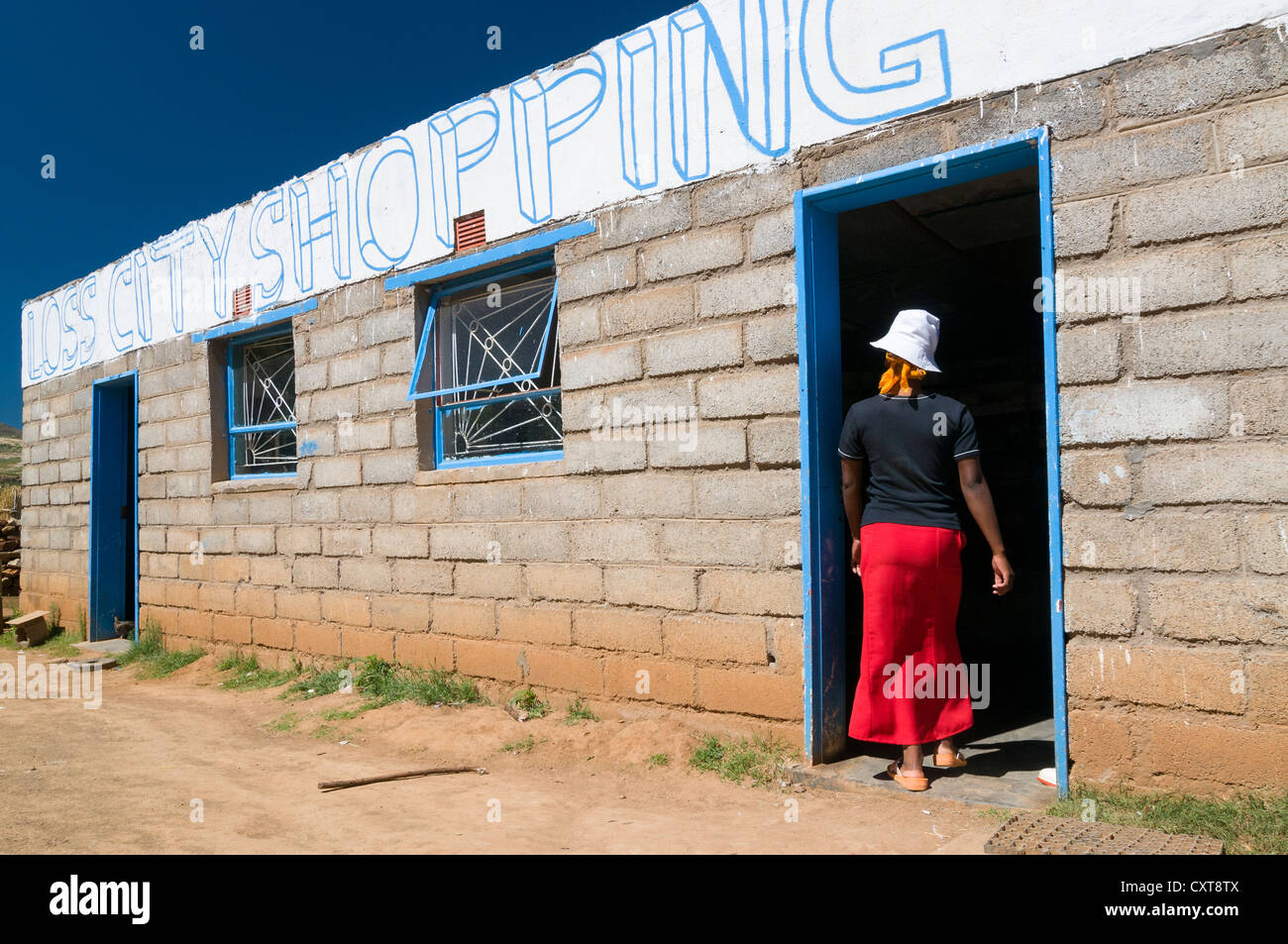 Basotho woman standing at the door of a shop, Drakensberg, Kingdom of Lesotho, southern Africa Stock Photo