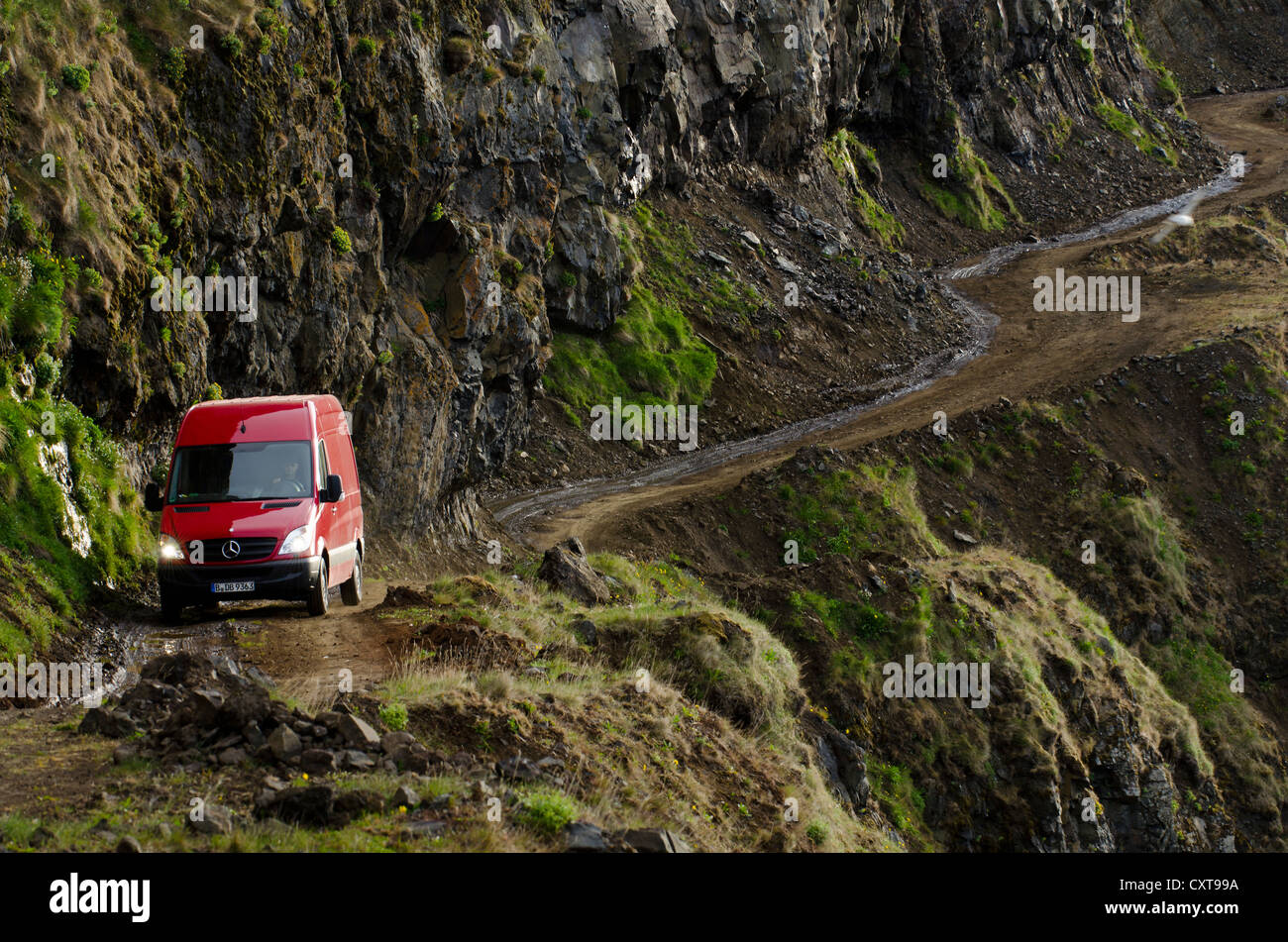 Car on a dangerous dirt road near the village of Þingeyri, Thingeyri