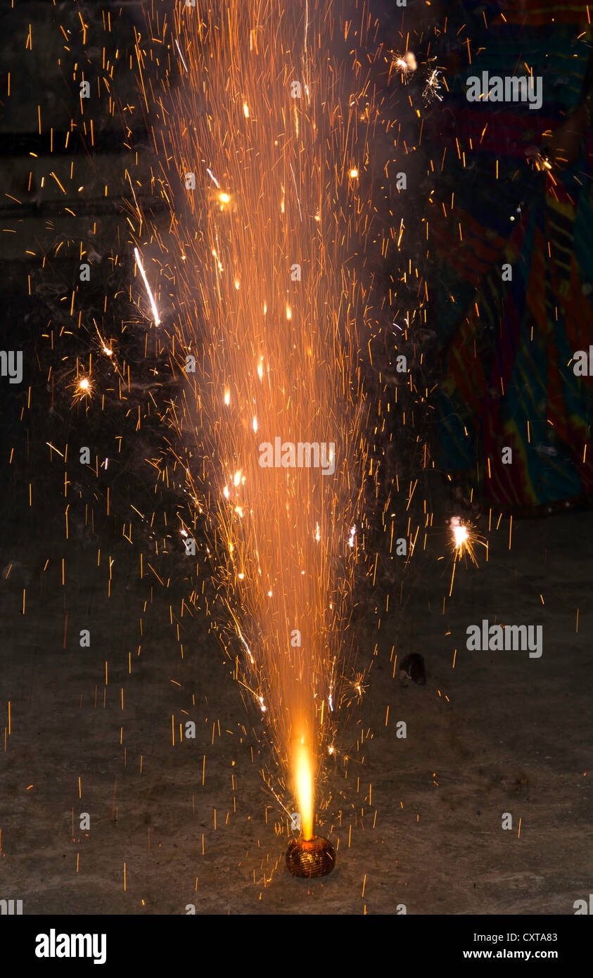 A fire cracker emitting colored sparks during the festival of Diwali