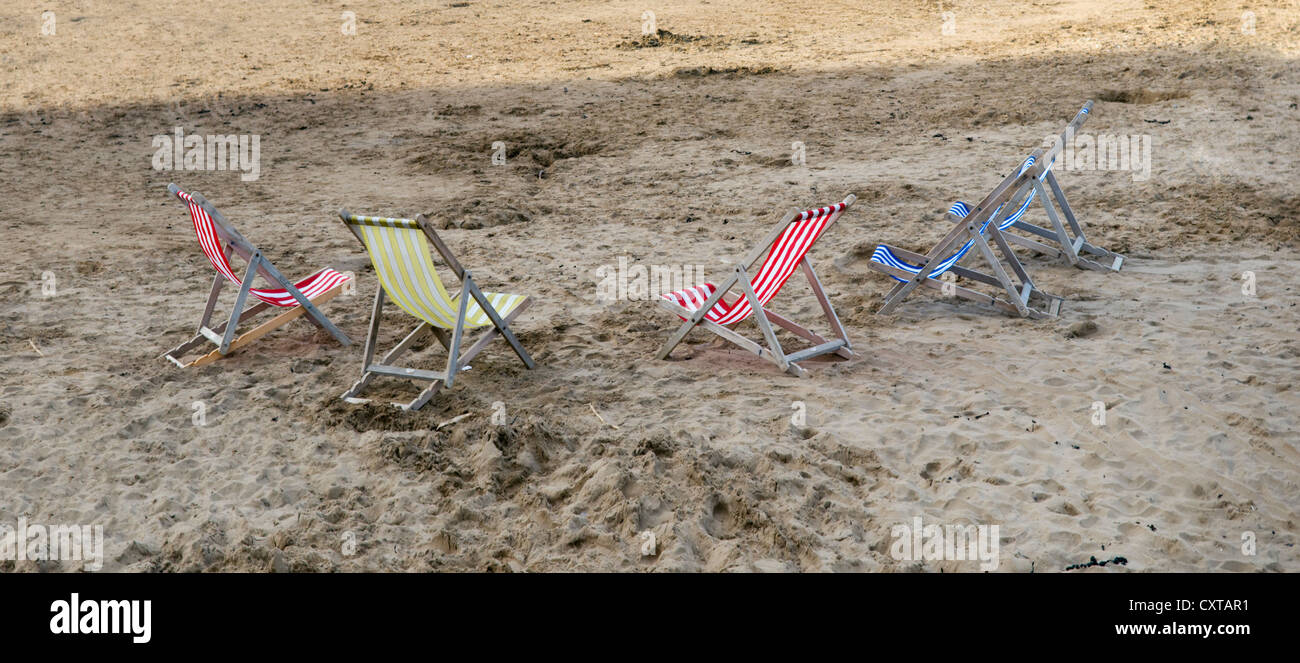 Five deck chairs on beach at Weston Super Mare, England, UK Stock Photo