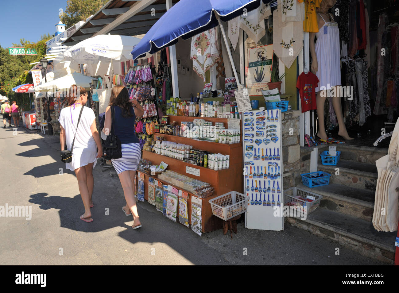 Tourist shopping for souvenirs at market stalls on street of Zia, island of Kos, Greece Stock Photo