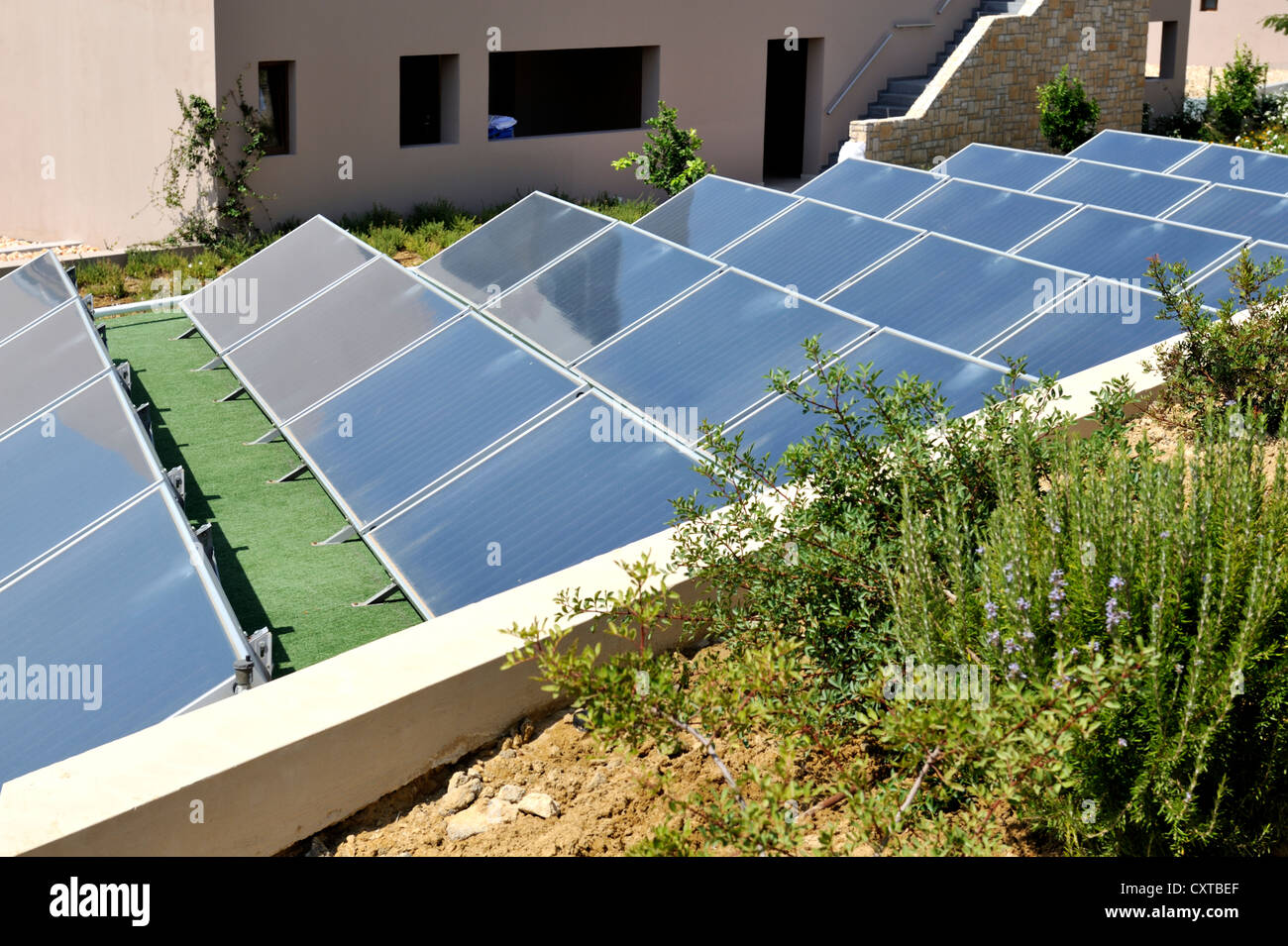 Solar thermal collectors. Roof top array on resort building, Greece Stock Photo