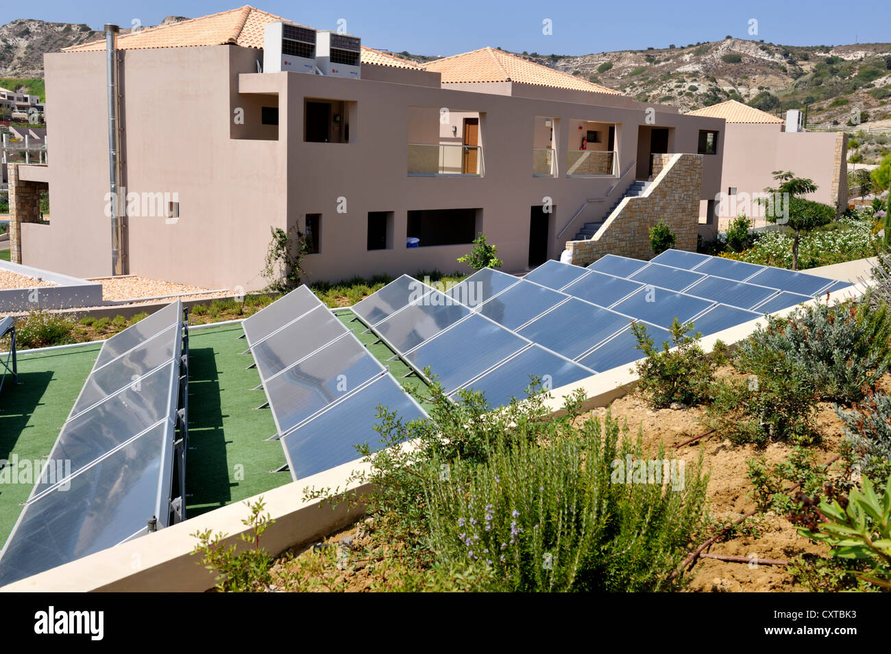 Solar thermal collectors. Roof top array on resort building, Greece Stock Photo