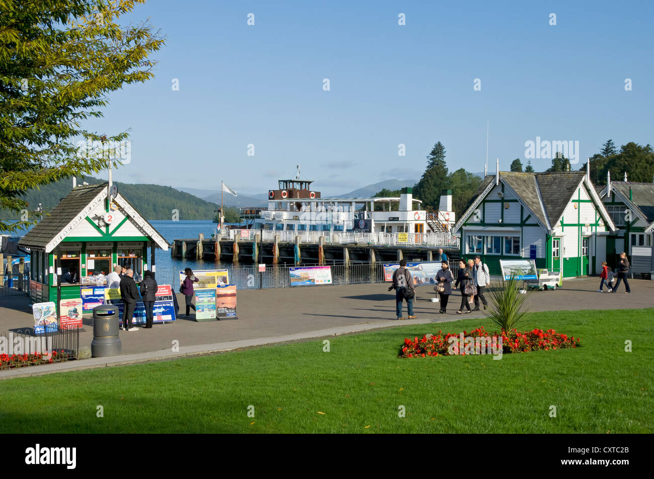 People tourists visitors walking along the promenade in summer Bowness on Windermere Cumbria England UK United Kingdom GB Great Britain Stock Photo