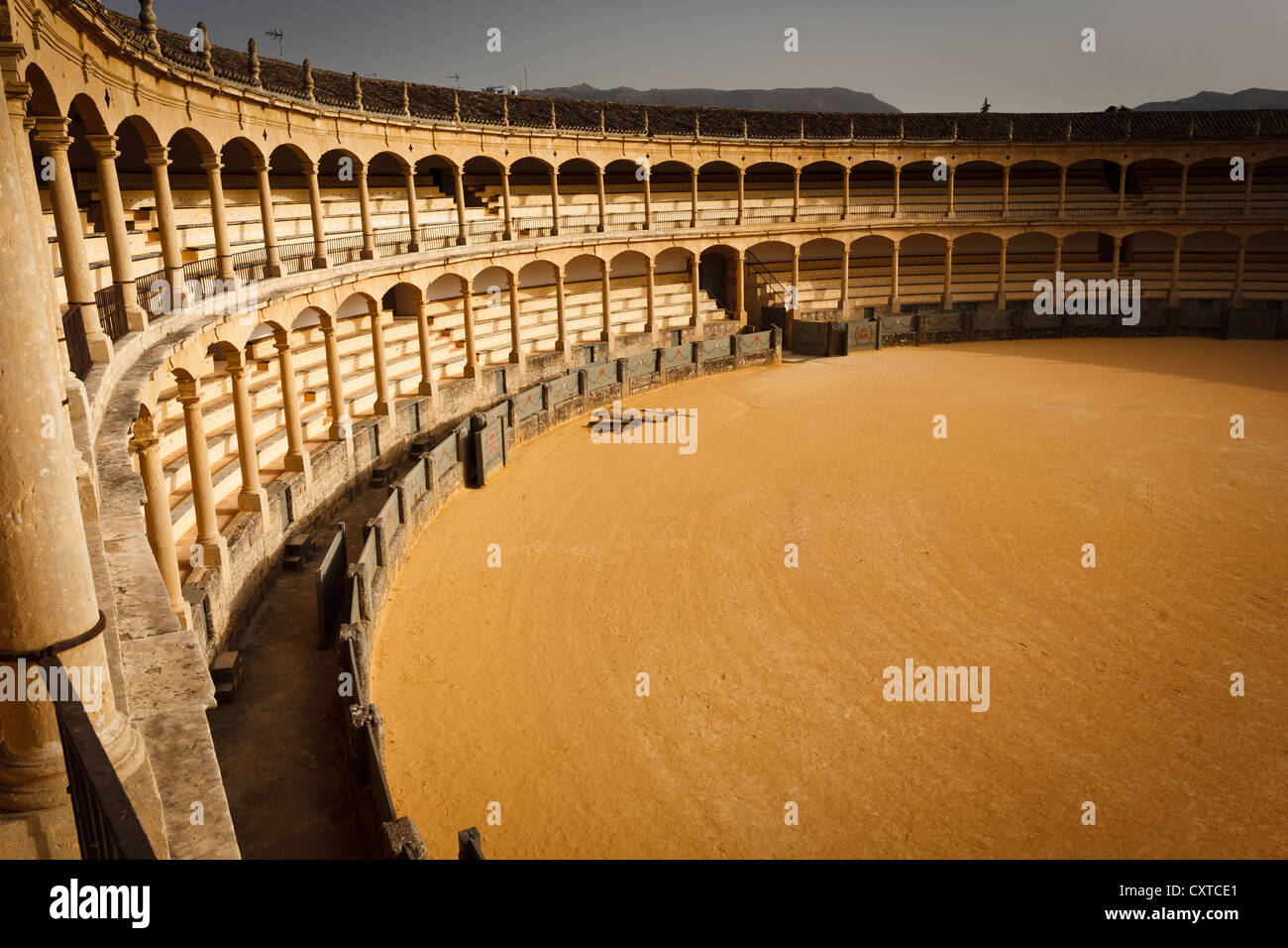 Interior view from the top of the sunlit side of the empty bullfight arena in Ronda, Spain Stock Photo