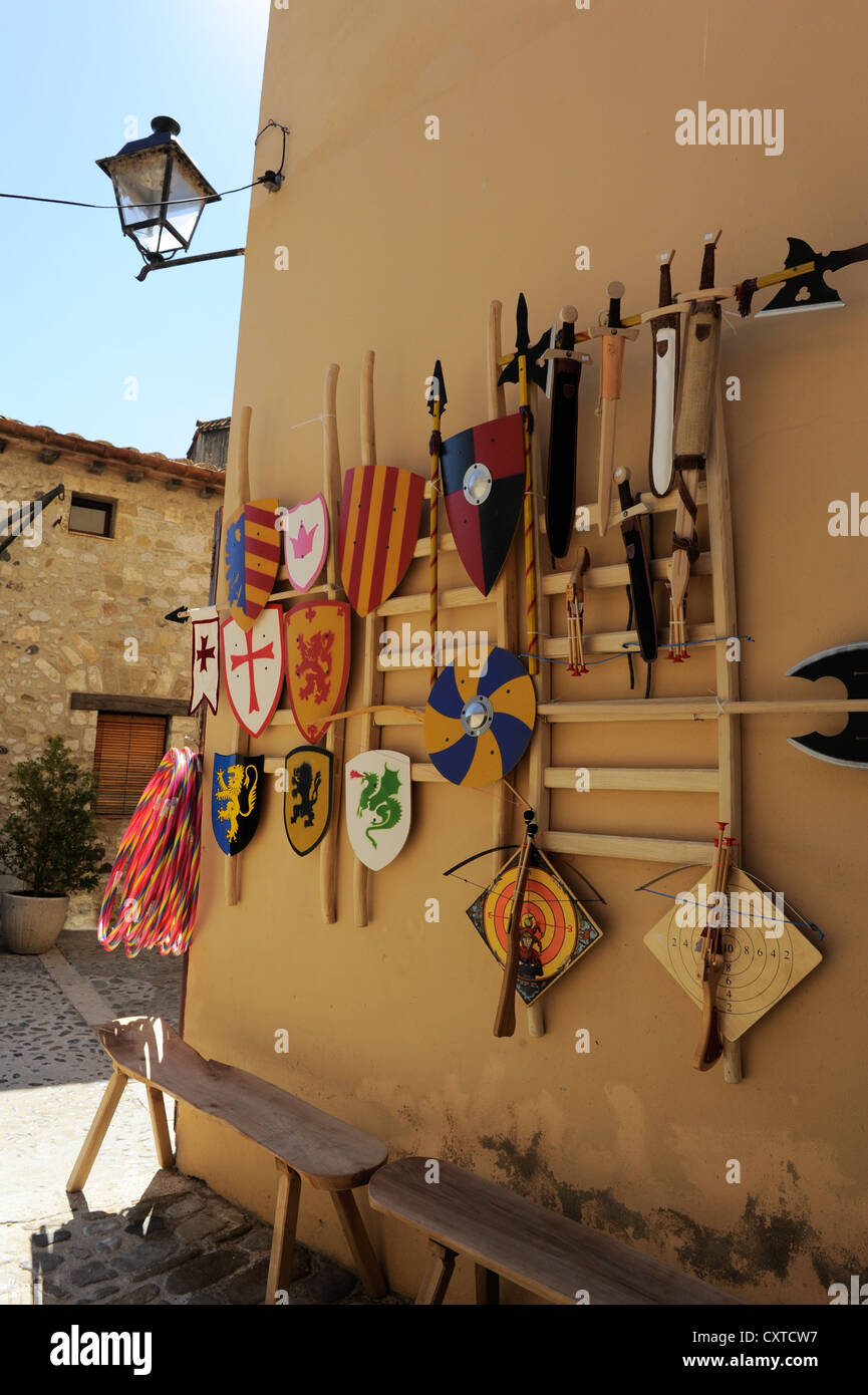 Wooden weapons, including shield, sword, bow and arrow, spear and dagger for sale in a tourist shop in Besalu, Spain Stock Photo