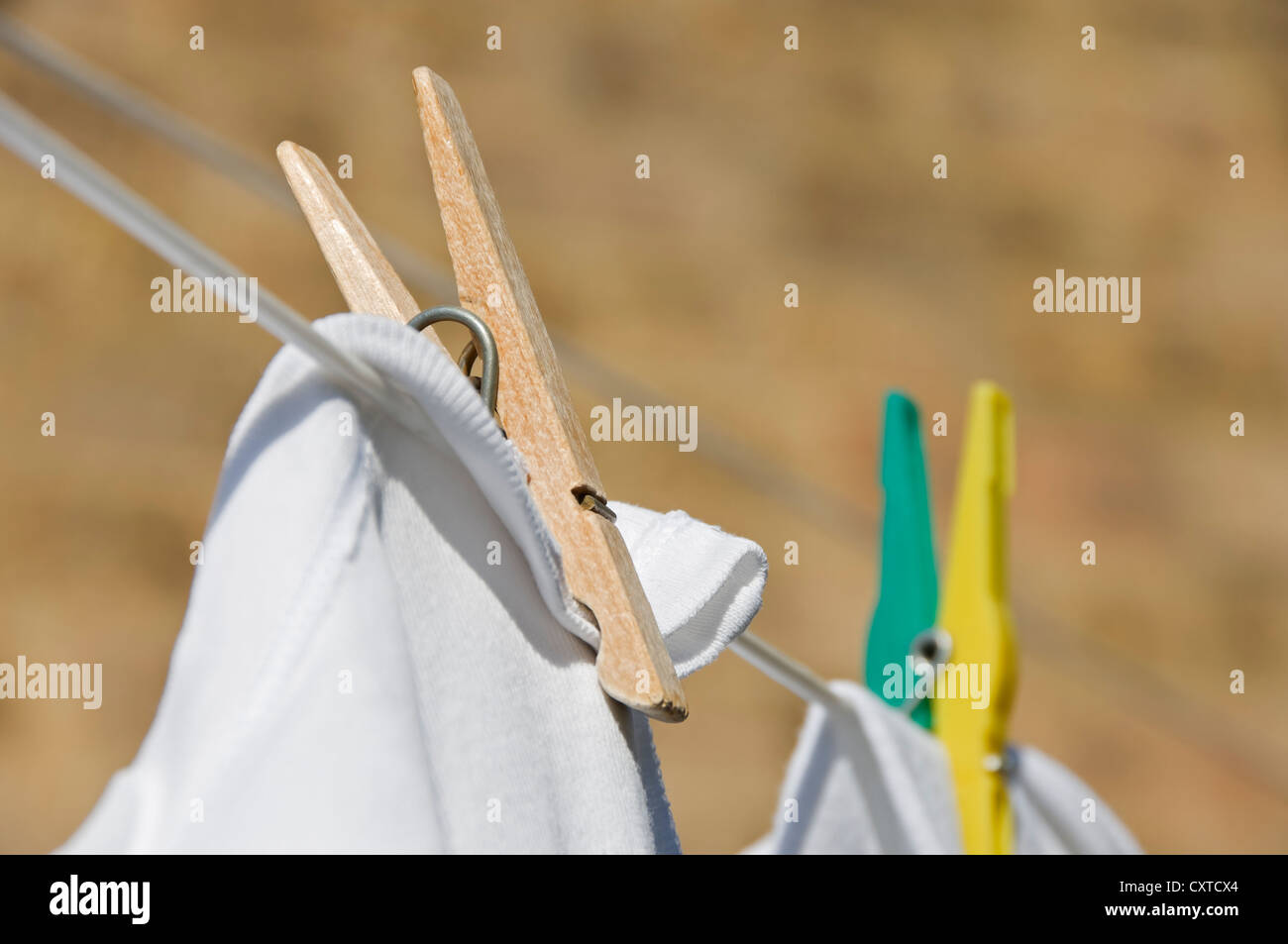 Close up of wooden and plastic clothes pegs peg on washing line England UK United Kingdom GB Great Britain Stock Photo