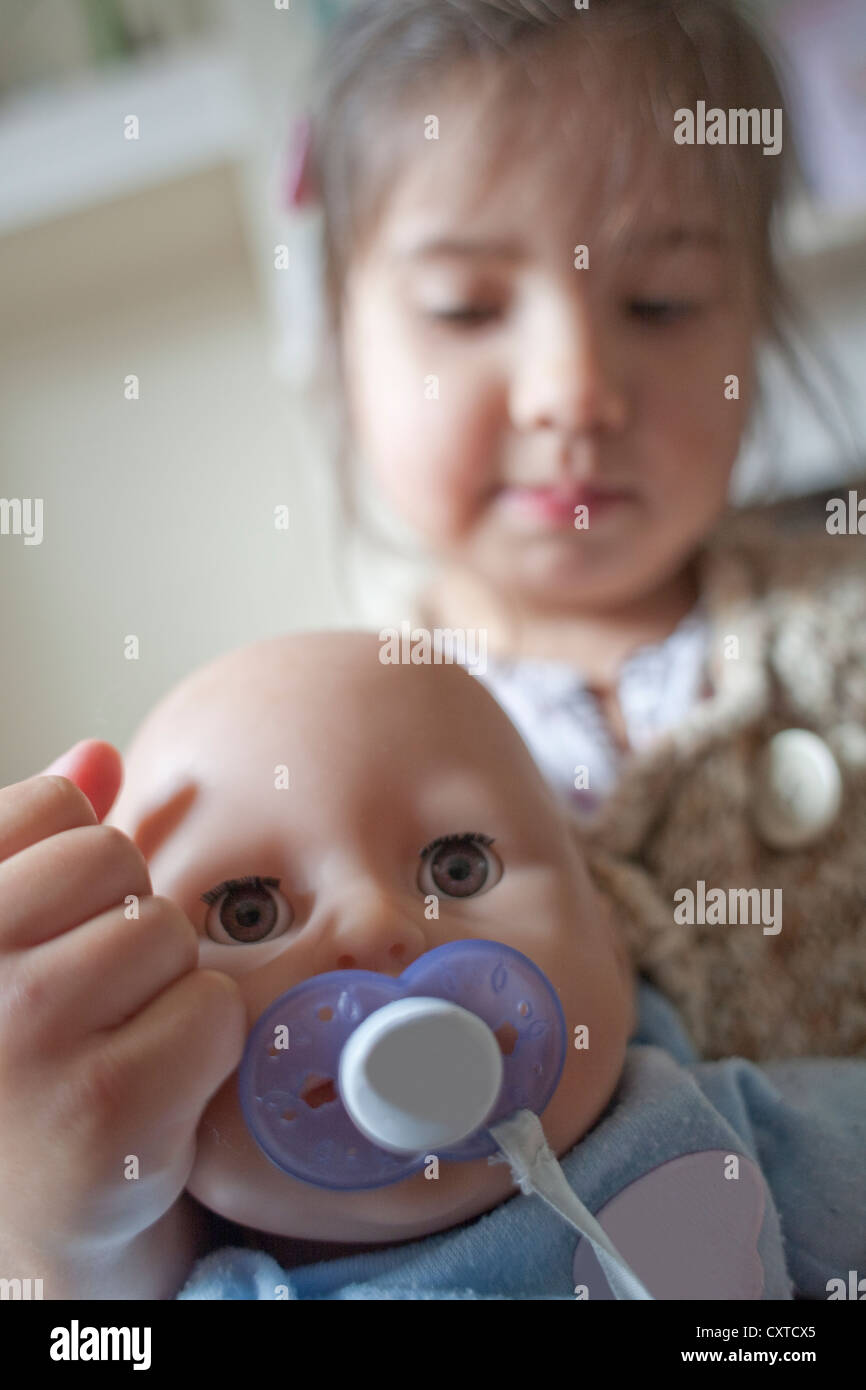 Close up of young girl playing with doll, focus on foreground Stock ...