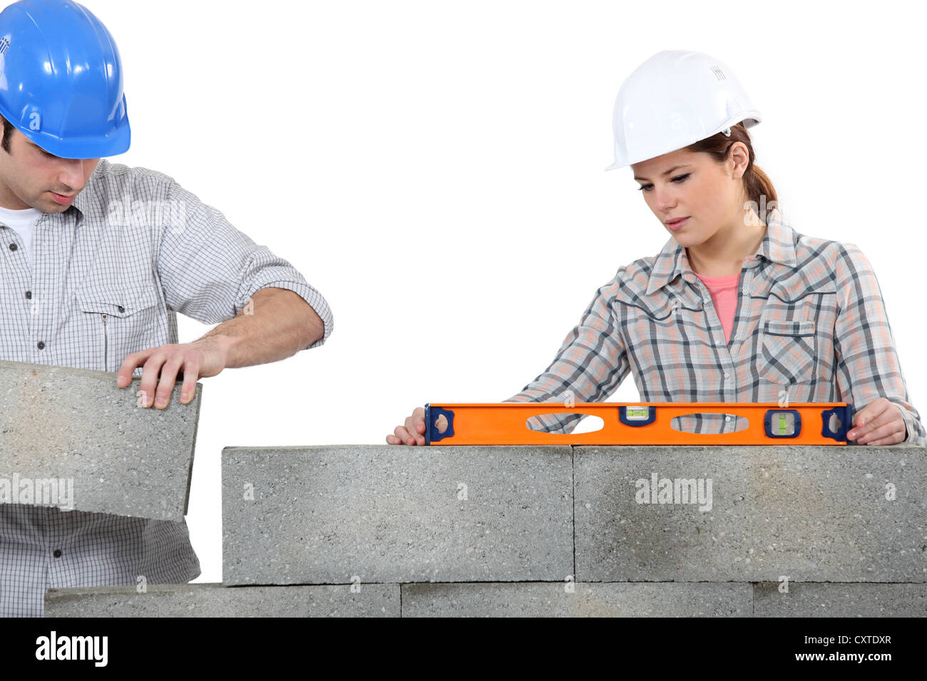 Man and woman masons stacking bricks Stock Photo - Alamy