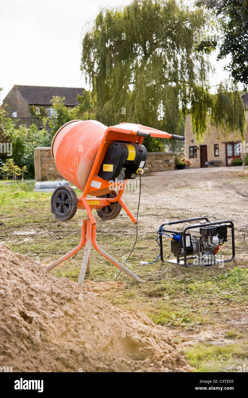 Electric Cement Mixer on a building site powered by a Generator Stock