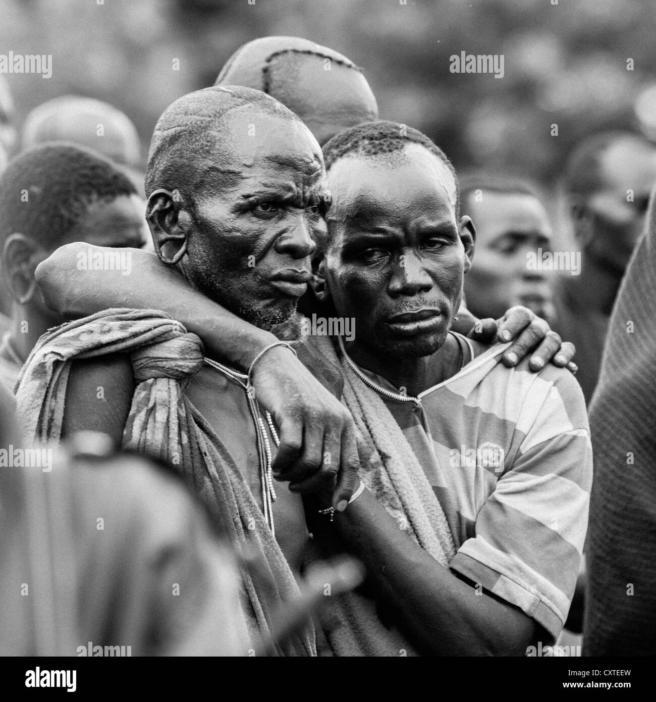 Suri Tribe Men Holding Eachother At A Ceremony Organized By The Government, Kibish, Omo Valley, Ethiopia Stock Photo
