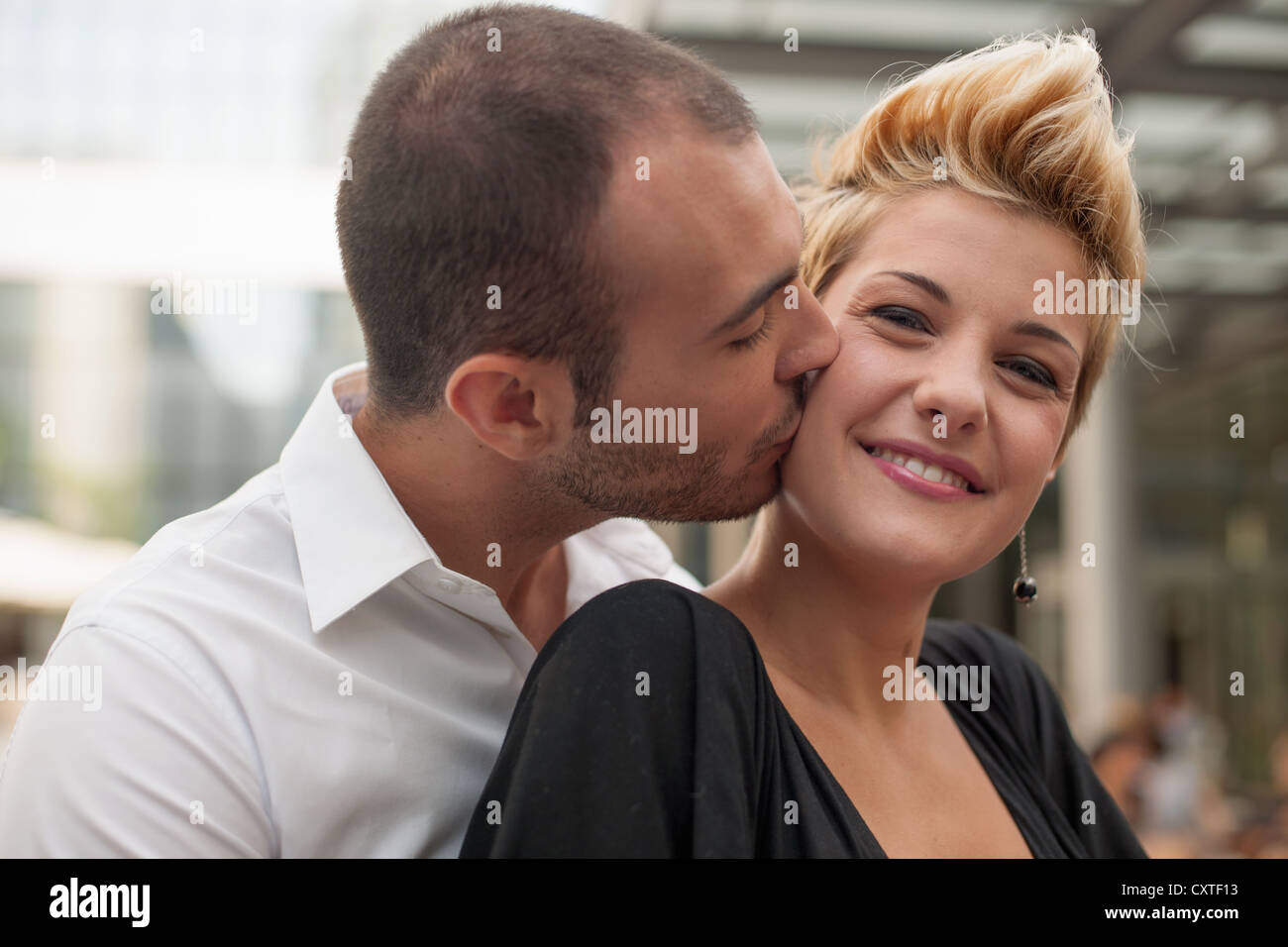 Smiling couple kissing outdoors Stock Photo