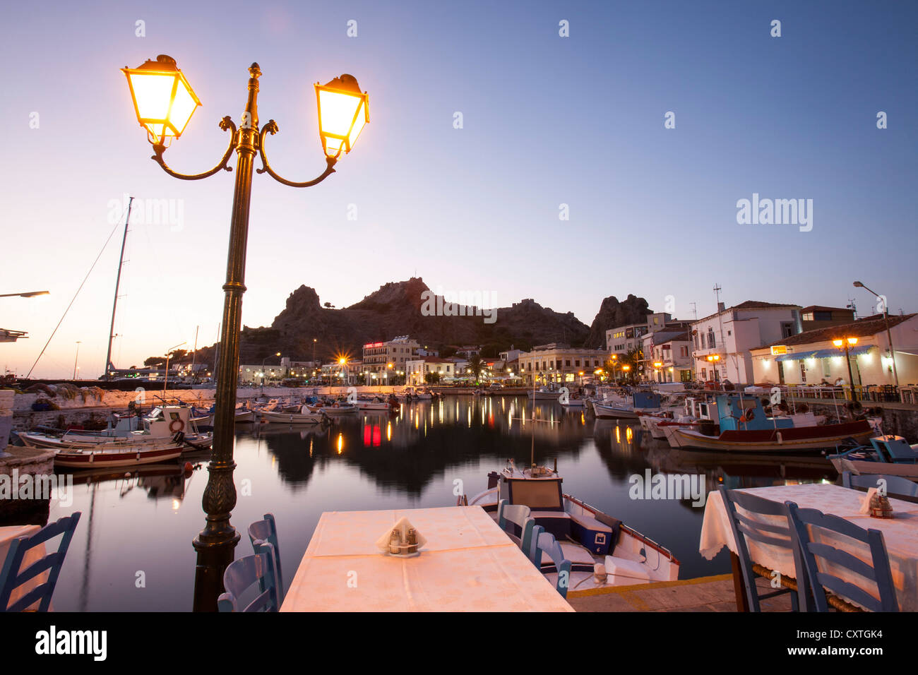 Myrina harbour and taverna's at dusk on Lemnos, Greece. Stock Photo