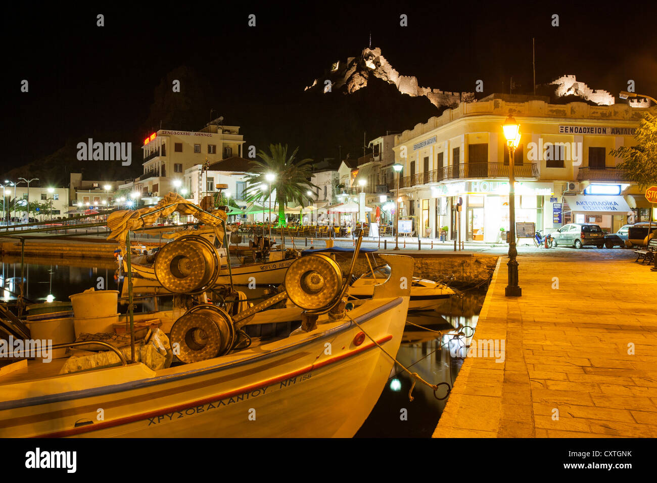 Myrina harbour and taverna's at dusk on Lemnos, Greece. Stock Photo