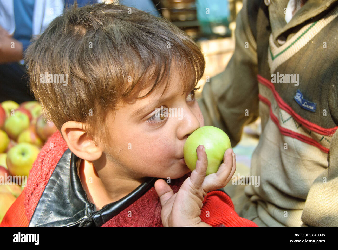 A local Kashmir boy and an apple. Stock Photo