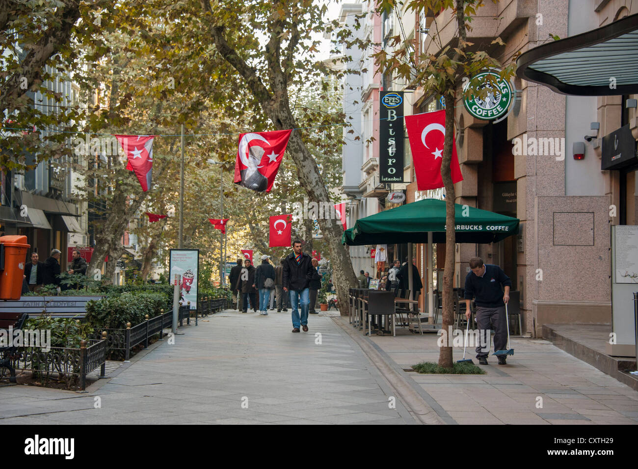 Pedestrian street with large Turkish flags near the Grand Bazaar in Istanbul Turkey Stock Photo