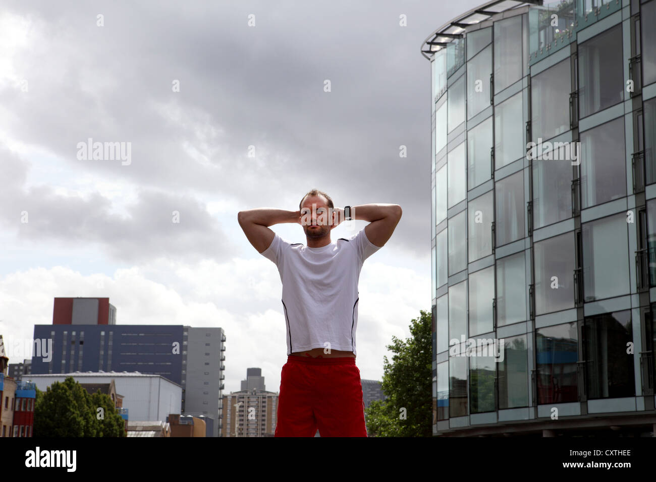 Runner Stretching On City Street Stock Photo Alamy