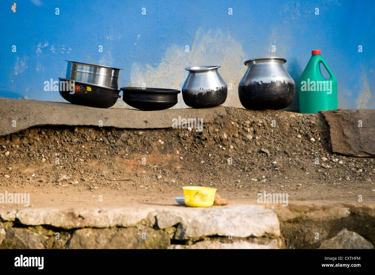 Horizontal view of an assortment of pots and containers washed up and clean on the side of the river in the backwaters of Kerala Stock Photo