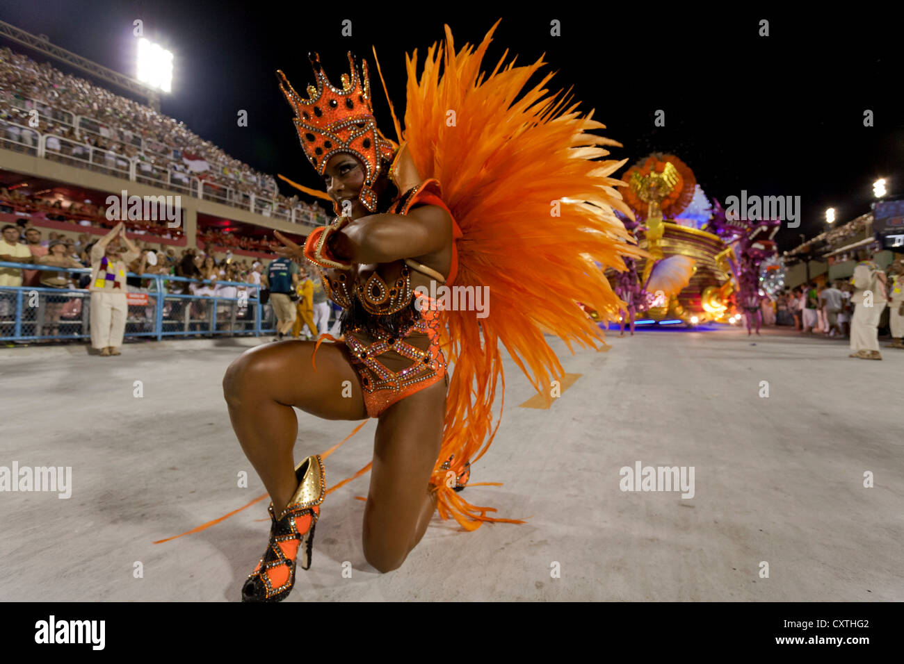Woman Kneeling in Bright Orange Costume During Carnival Parade Rio de Janeiro Brazil Stock Photo