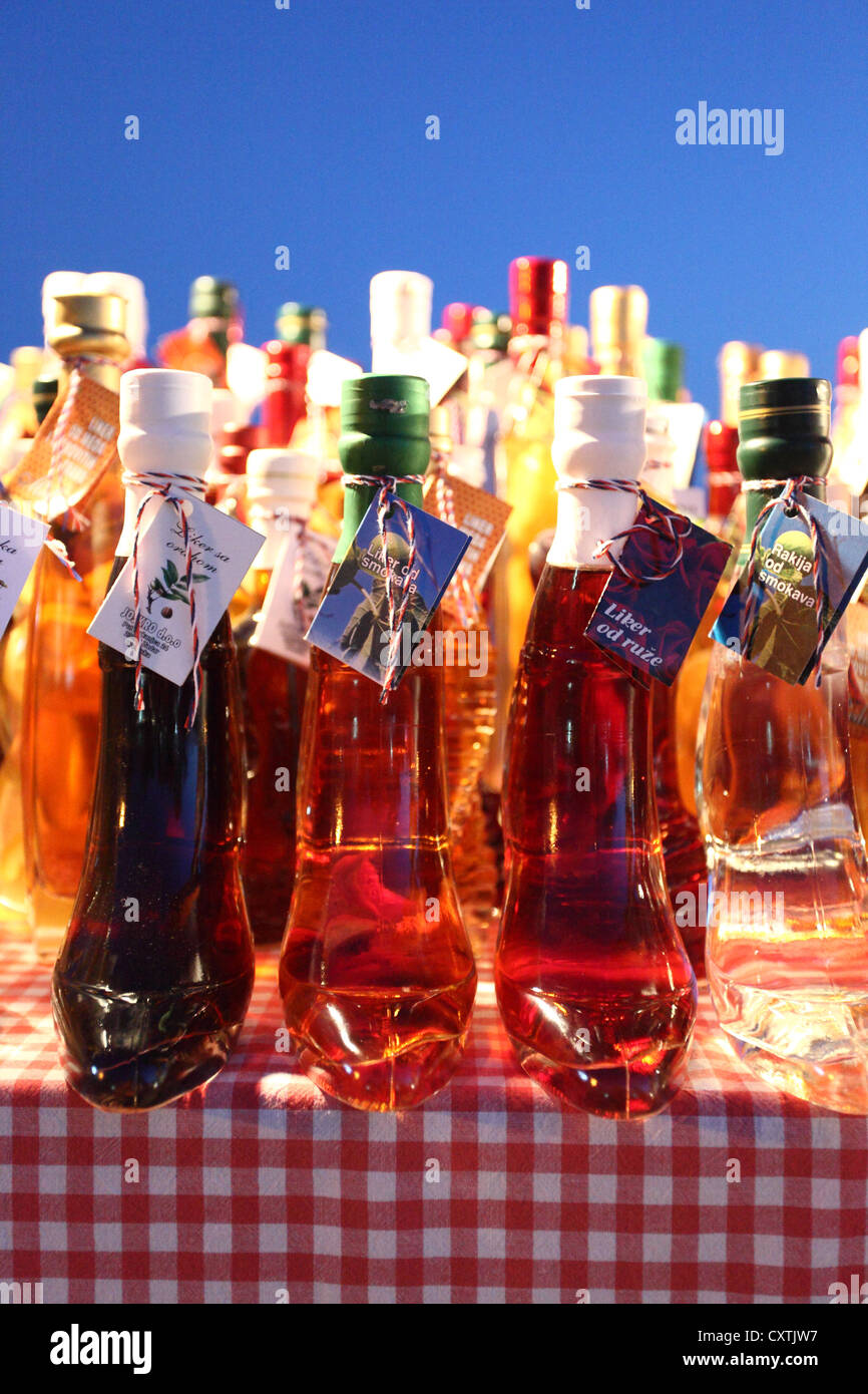 Traditional distillates on display at the market stall in Sveti Filip i Jakov, Croatia. Stock Photo