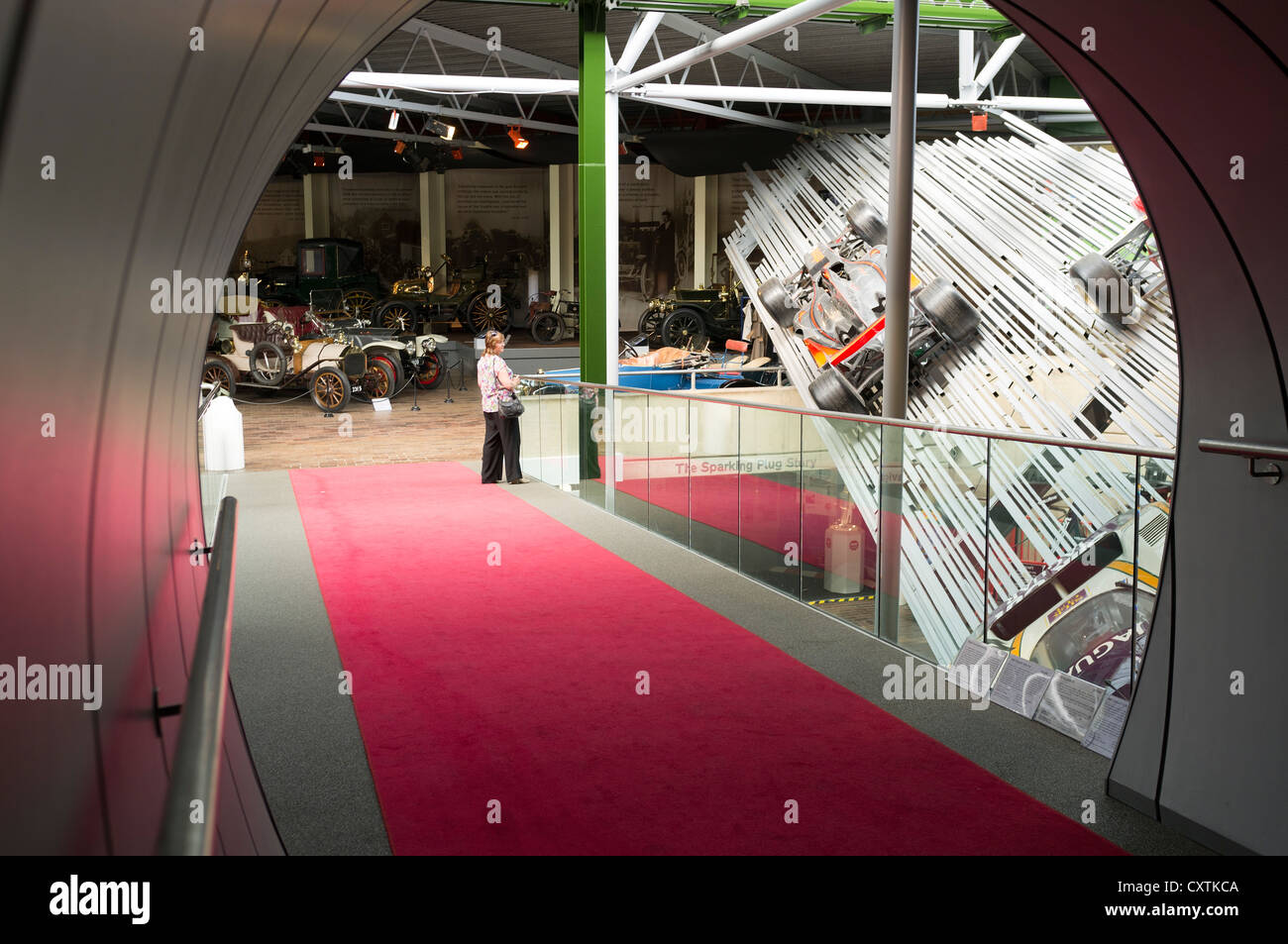 dh British National Motor museum BEAULIEU MUSEUMS HAMPSHIRE ENGLAND Woman looking at racing cars vistor uk visitors display Stock Photo