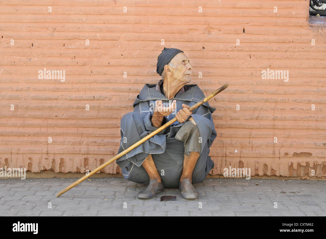 A street beggar in the old Medina centre of Marrakech, Morroco Stock Photo