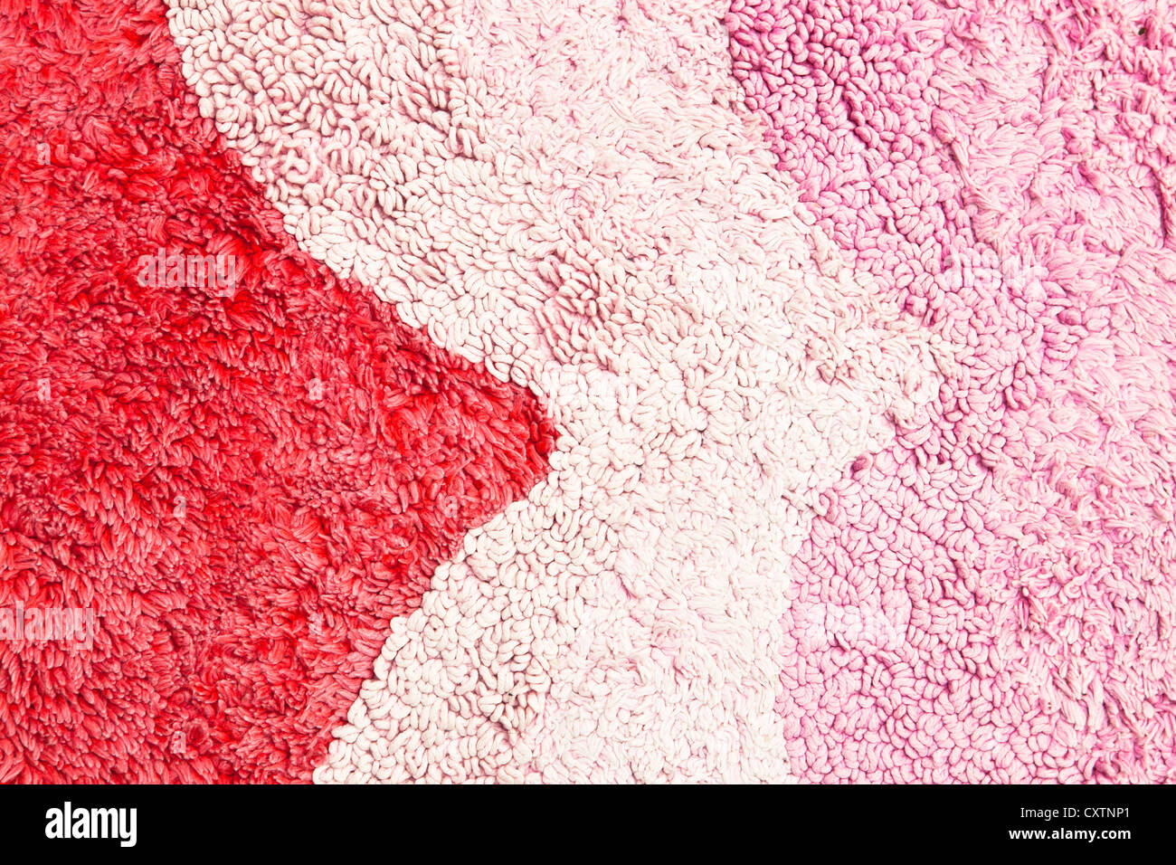 Pink and red rug pattern as a background image Stock Photo - Alamy
