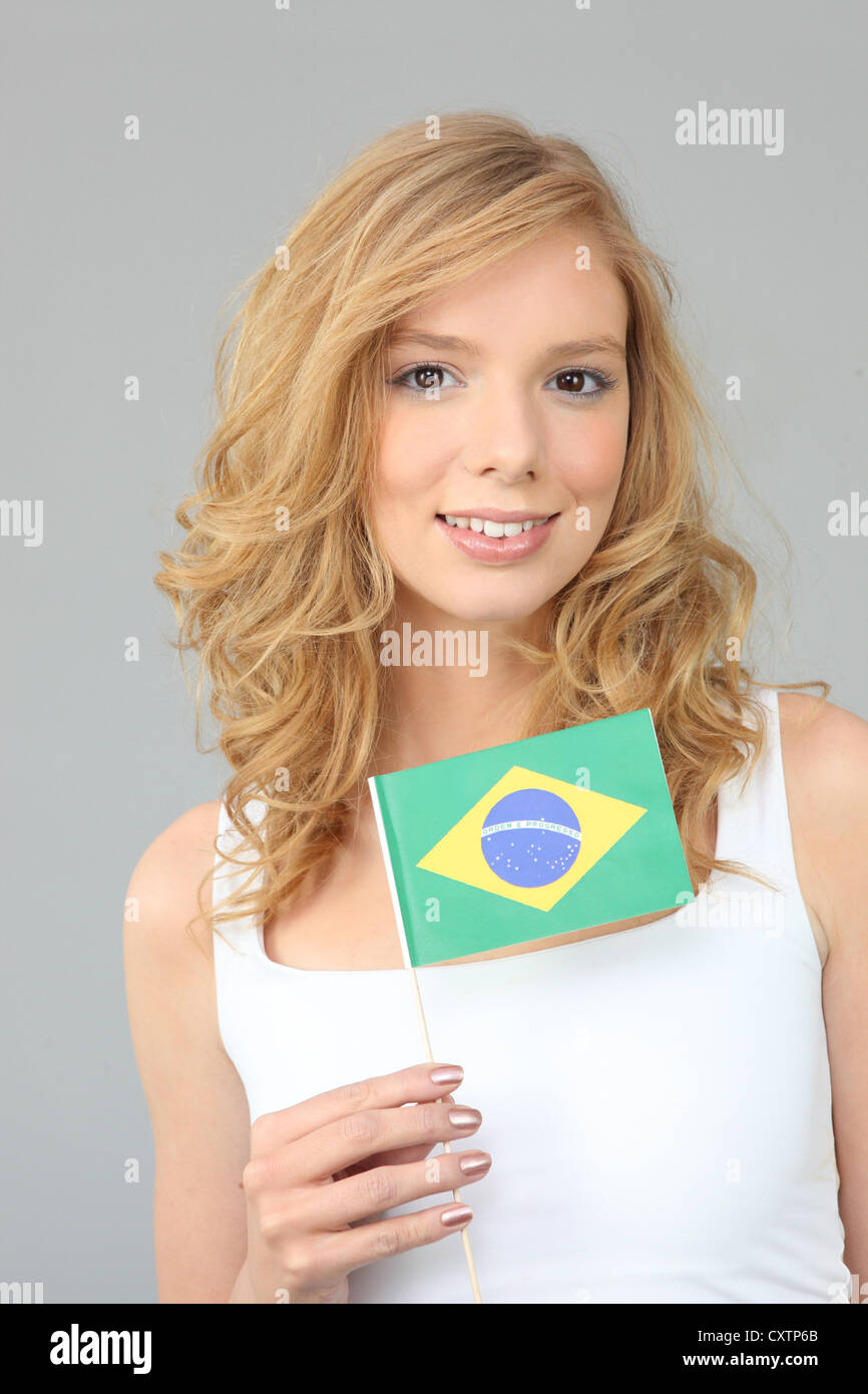 a blonde woman showing a Brazilian flag Stock Photo Alamy