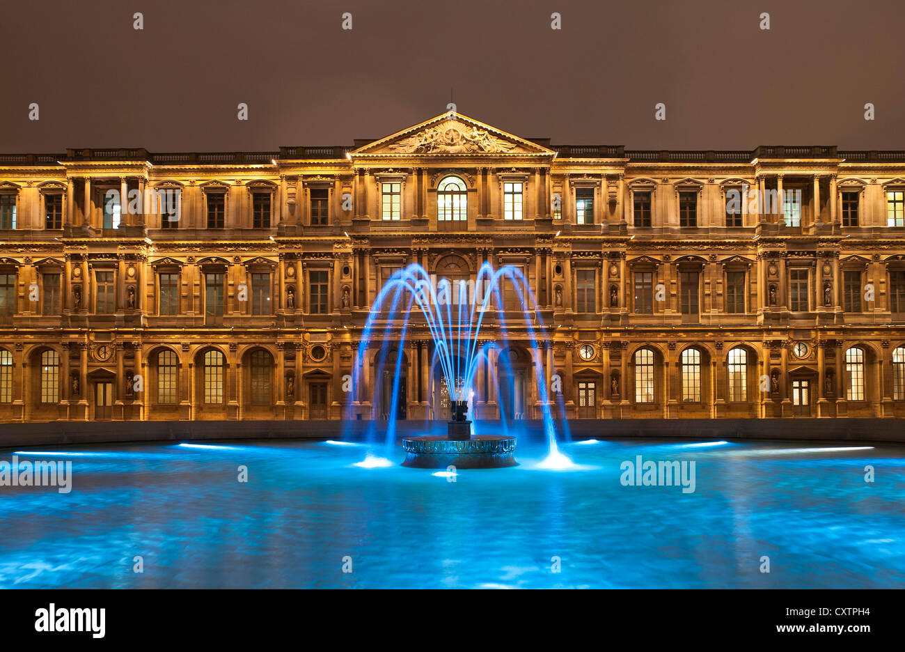 The Louvre museum at night, Paris, France Stock Photo