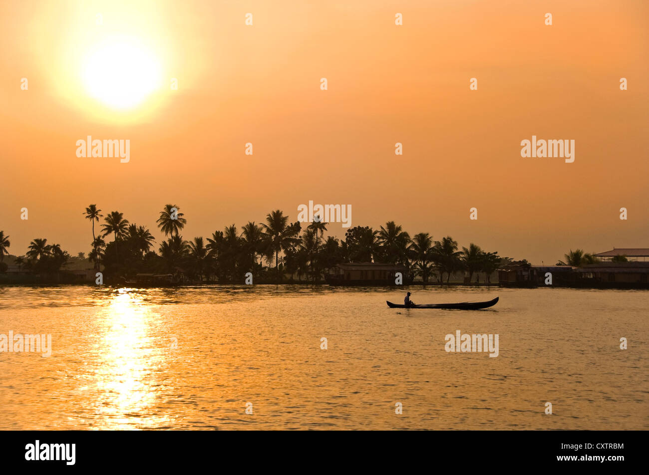 Horizontal view of a beautiful orange sunset in the backwaters of Kerala. Stock Photo