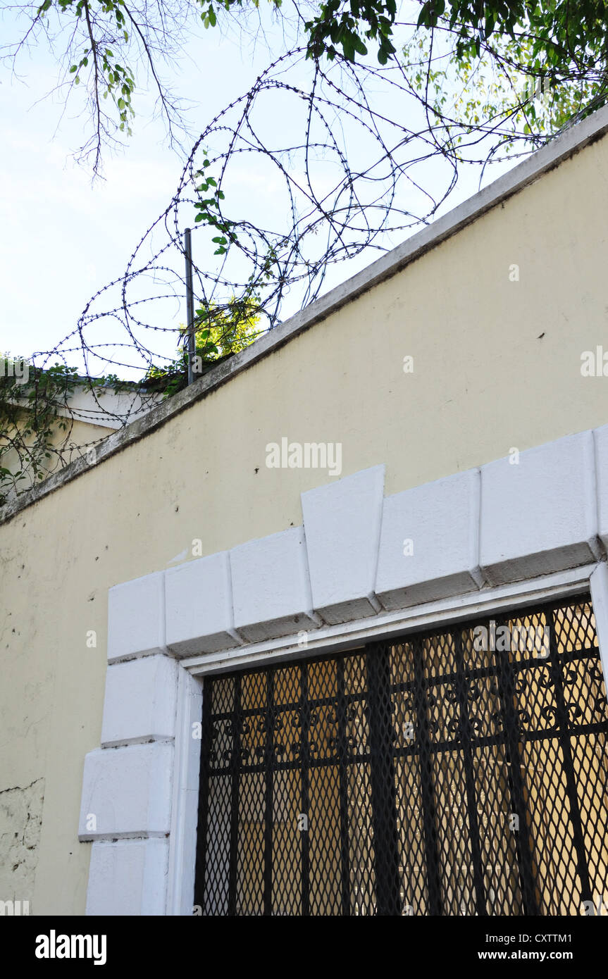 Barbed razor wire on building Stock Photo - Alamy