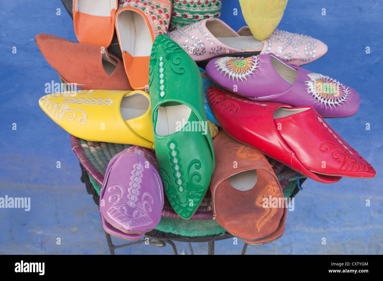 Chefchaouen, Morocco. Display of coloured leather slippers called babouches. Stock Photo
